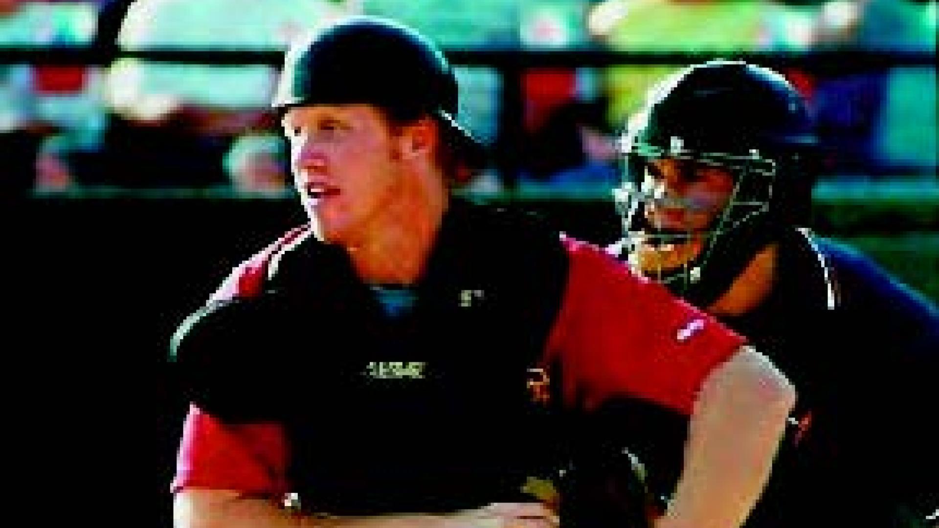 Graig Merritt runs to throw a ball at a baseball stadium.